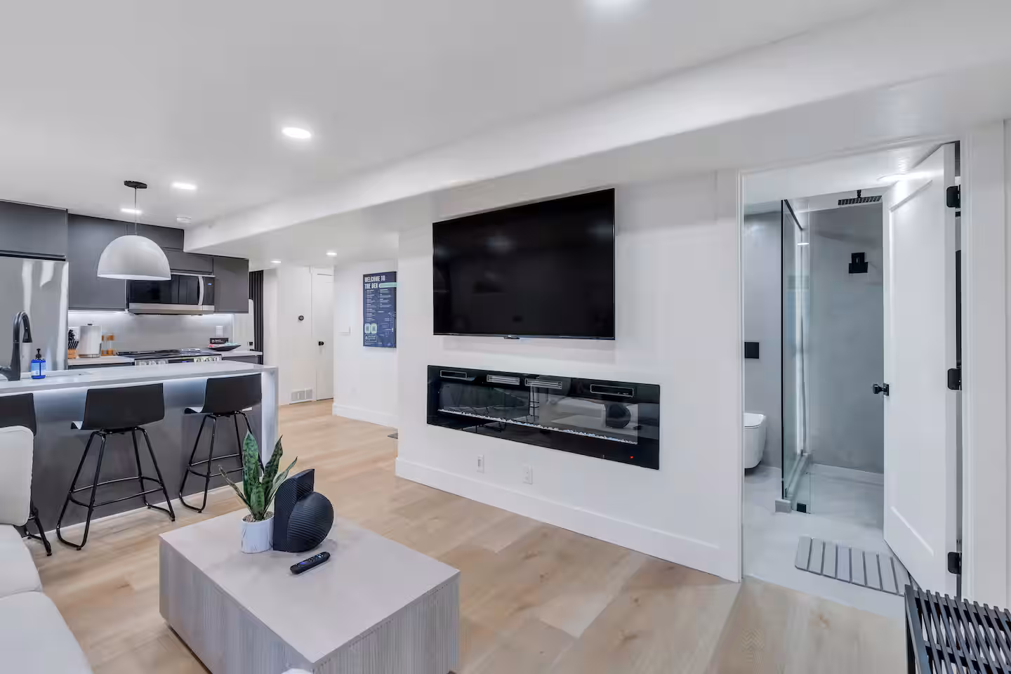 65 inch Roku TV, coffee table, open concept living room and kitchen